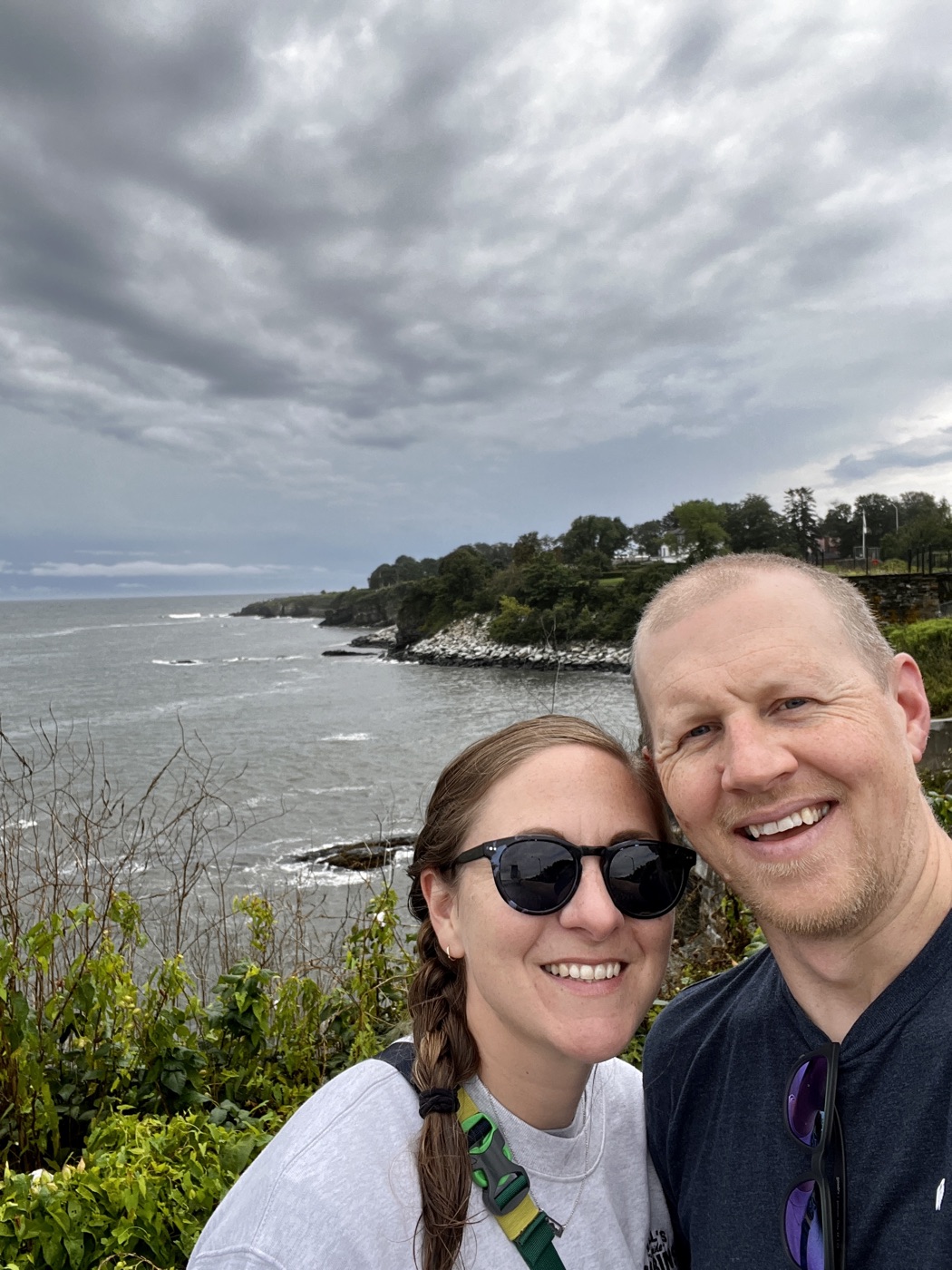 Martin and Katie on a rocky stretch of shoreline under a moody sky
