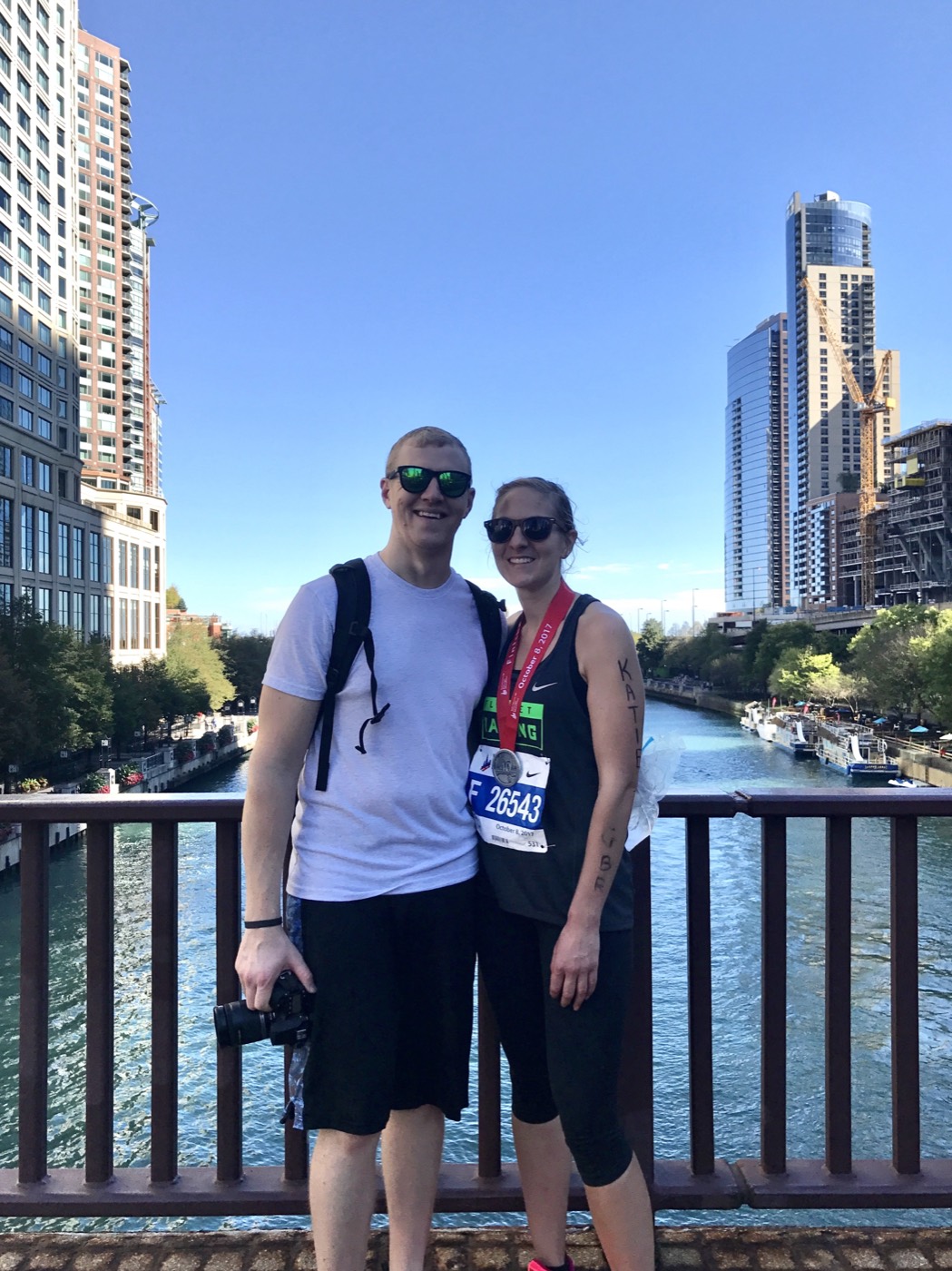 Martin and Katie on a bridge over the Chicago River, Katie wearing her marathon medal